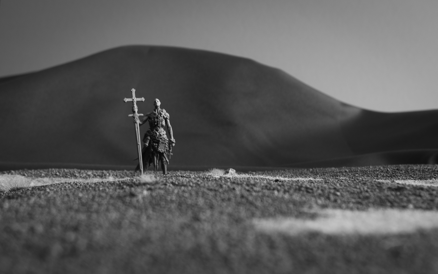 Forced Perspective Miniature Photography with a miniature in 28mm scale and a mountain range in the background.